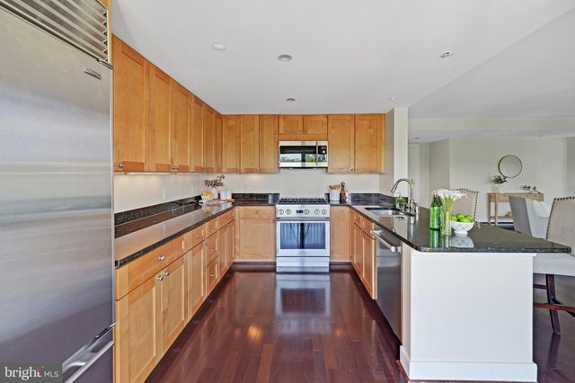 a bed room with a bed and a painting on the wall