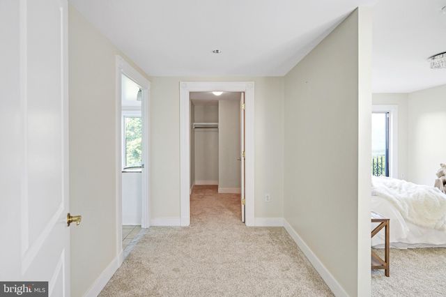a spacious bathroom with a granite countertop sink a mirror and a bathtub