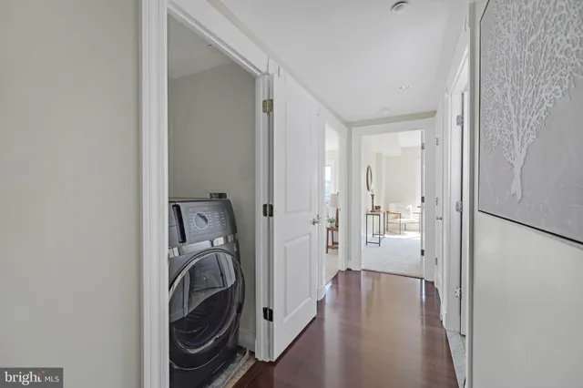 a bedroom with bed a lamp and a large mirror