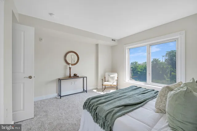 a living room with furniture and a book shelf