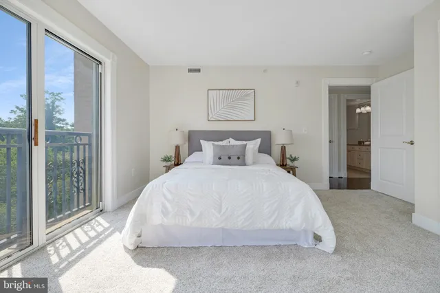a view of a swimming pool with a table and chairs under an umbrella