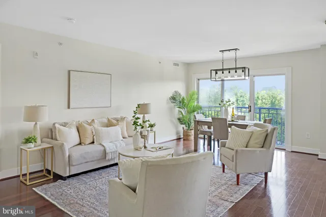 a kitchen with stainless steel appliances a table chairs and a large window