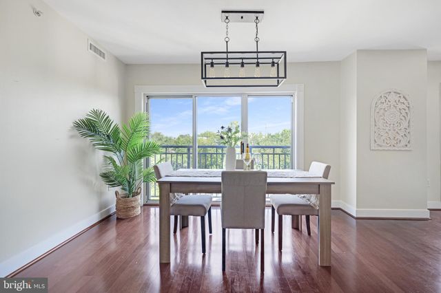 a kitchen with stainless steel appliances kitchen island wooden cabinets and a window