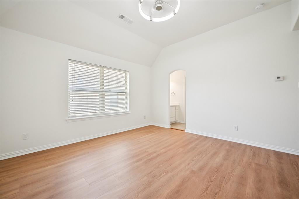 2029 Temperate Drive Allen, TX 75013 - Photo 27 of 40 an empty room with wooden floor and windows