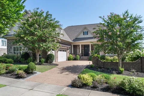 a front view of a house with a garden and outdoor seating