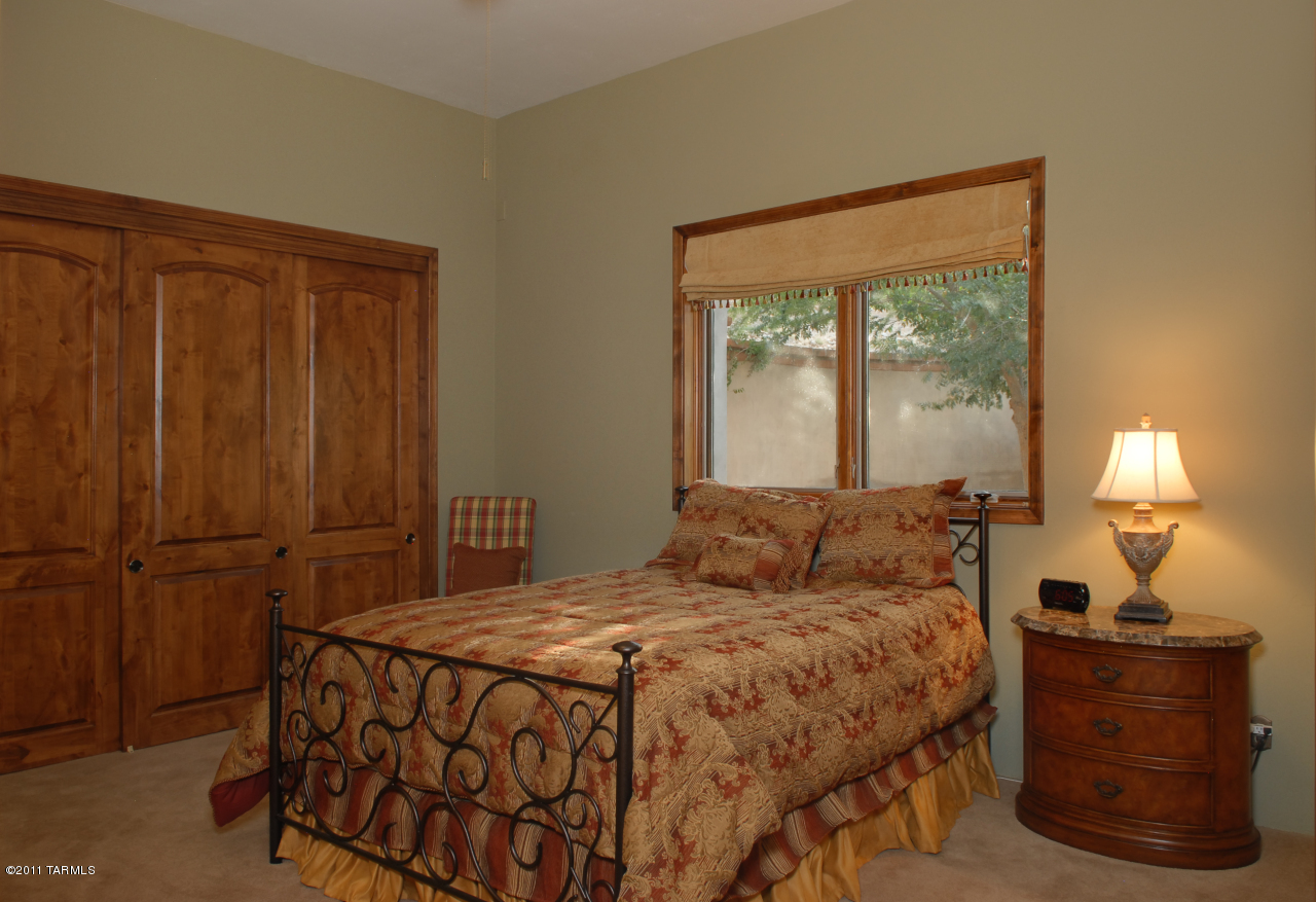 2188 East Buck Ridge Place Oro Valley, AZ 85737 - Photo 18 of 22 a bedroom with a bed and a mirror