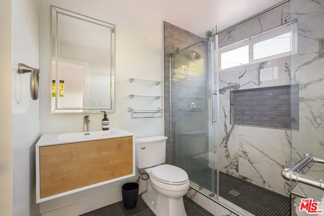 a bedroom with a large bed and a large window