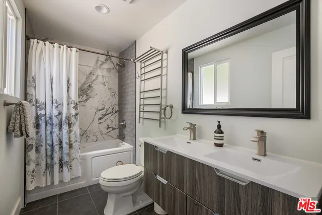 a view of a patio with table and chairs potted plants with wooden floor and fence