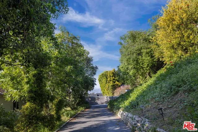 a view of a house with a yard and garden