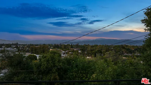 a view of houses with outdoor space and parking
