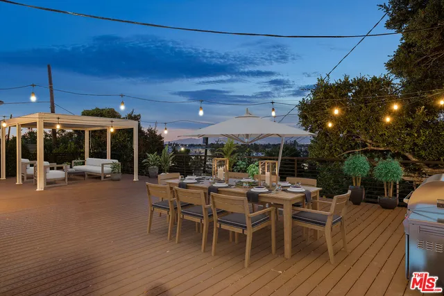 an aerial view of a house with outdoor space and trees all around