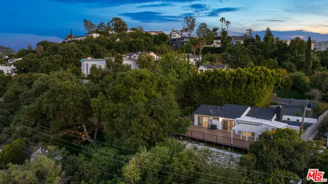 an aerial view of multiple houses with yard