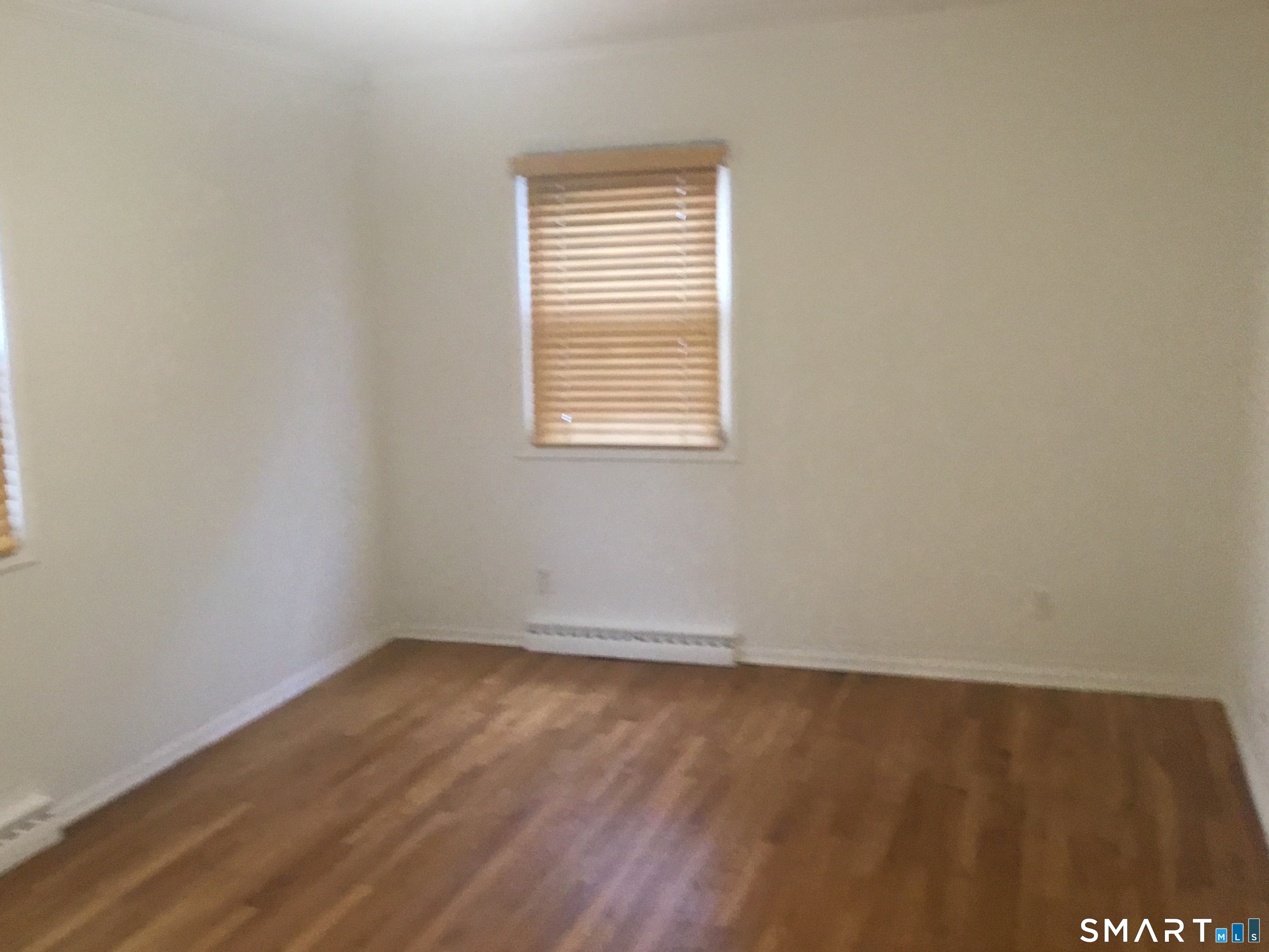 245 Unquowa Road, Unit 93 Fairfield, CT 06824 - Photo 9 of 11 an empty room with a window