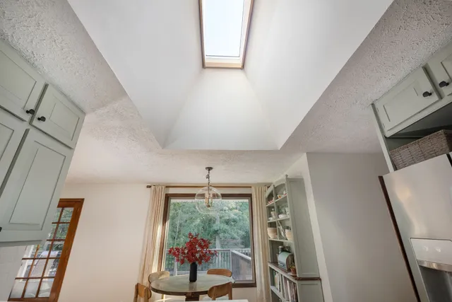 a kitchen with a stove a refrigerator and wooden floor