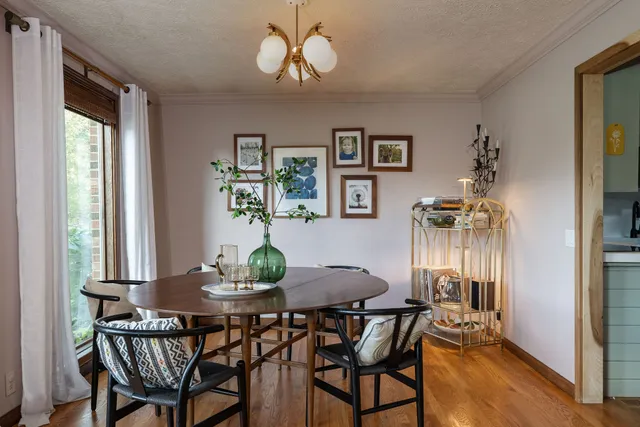 a living room with furniture a flat screen tv and a large window