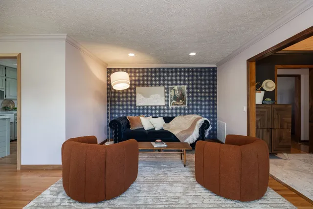 a living room with furniture a fireplace and a flat screen tv