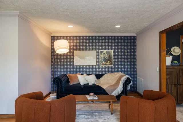 a living room with furniture and a fireplace