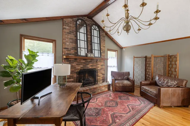 a bedroom with a bed and a flat tv screen on dresser