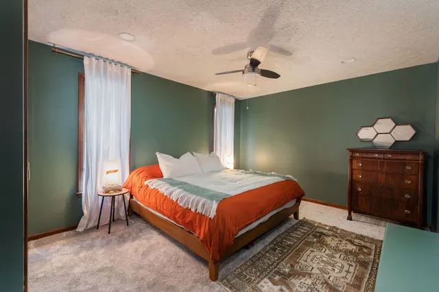 a view of empty room with wooden floor and a fireplace