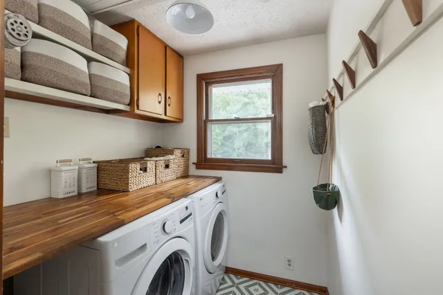 an aerial view of a house with garden space and trees