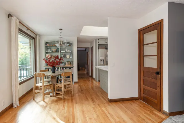 a kitchen with kitchen island white cabinets and stainless steel appliances