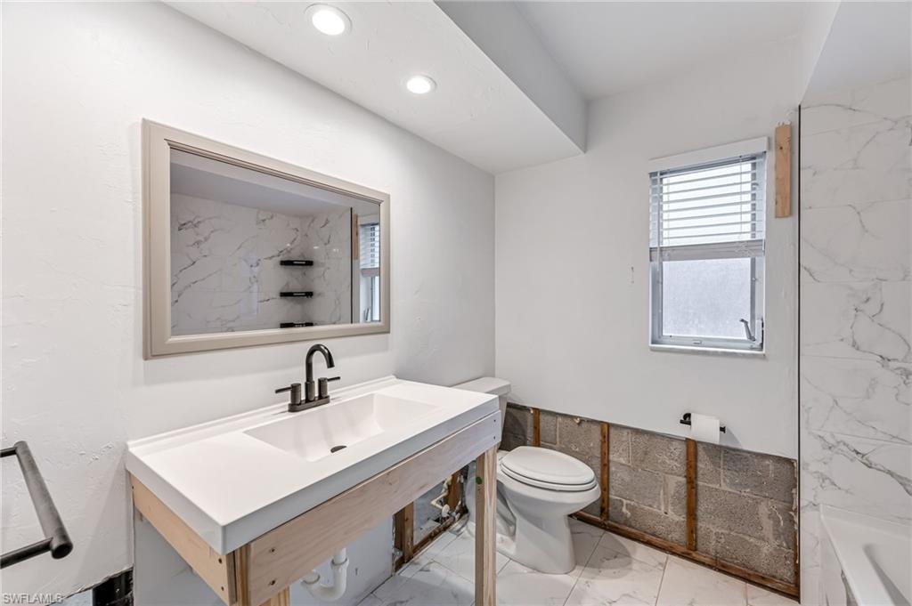 2472 Harbor Road Naples, FL 34104 - Photo 18 of 29 Bathroom with a bath, toilet, and sink