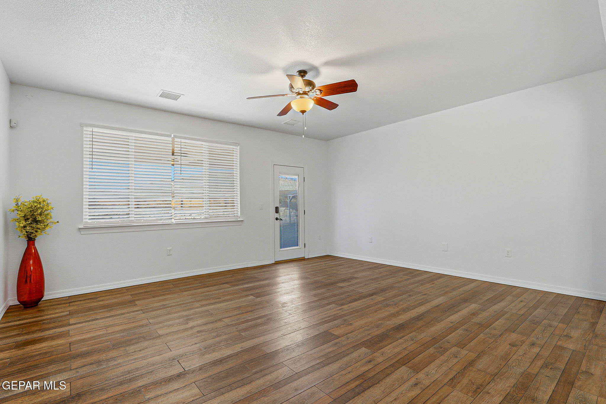 520 Gomez Road El Paso, TX 79932 - Photo 14 of 72 wooden floor in an empty room with a window