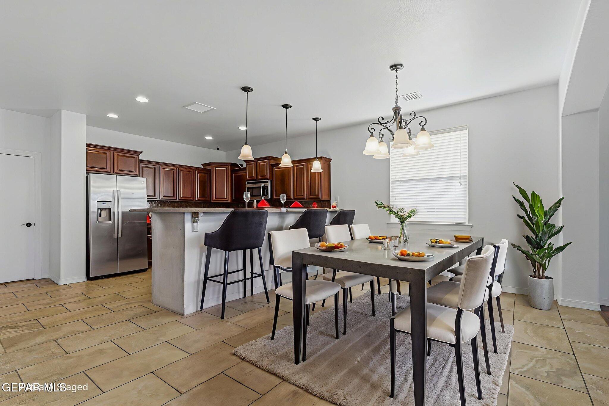 520 Gomez Road El Paso, TX 79932 - Photo 16 of 72 a view of a dining room with furniture and a chandelier
