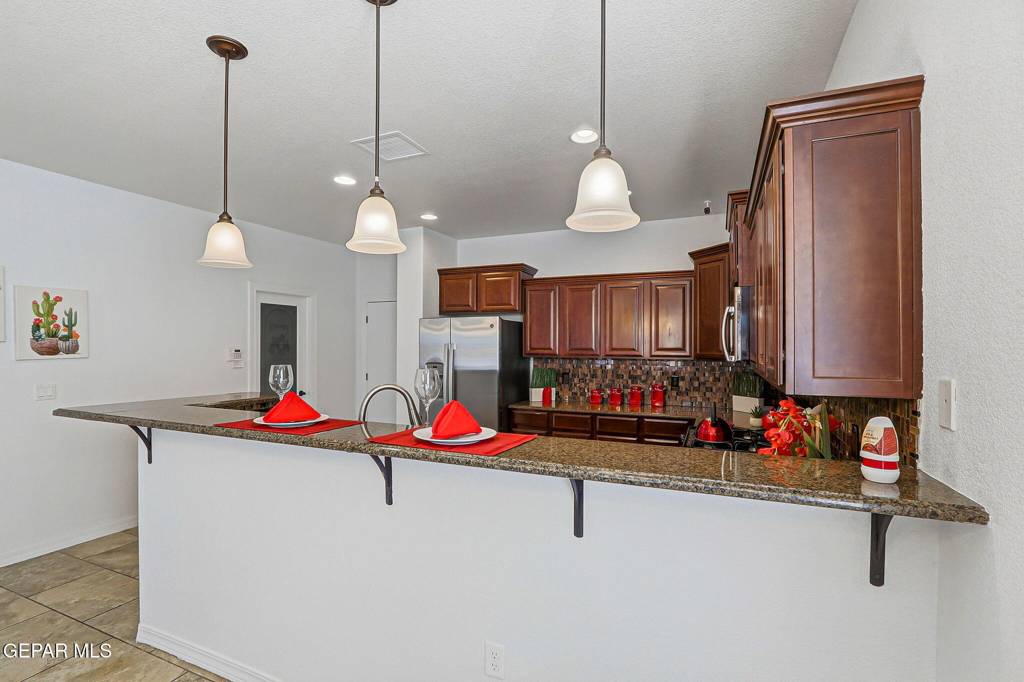 520 Gomez Road El Paso, TX 79932 - Photo 20 of 72 a kitchen with stainless steel appliances granite countertop a sink a stove and a wooden floors