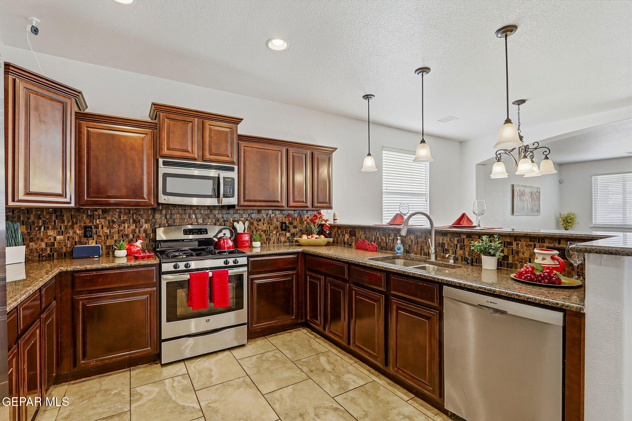 520 Gomez Road El Paso, TX 79932 - Photo 25 of 72 a kitchen with stainless steel appliances granite countertop a sink and cabinets