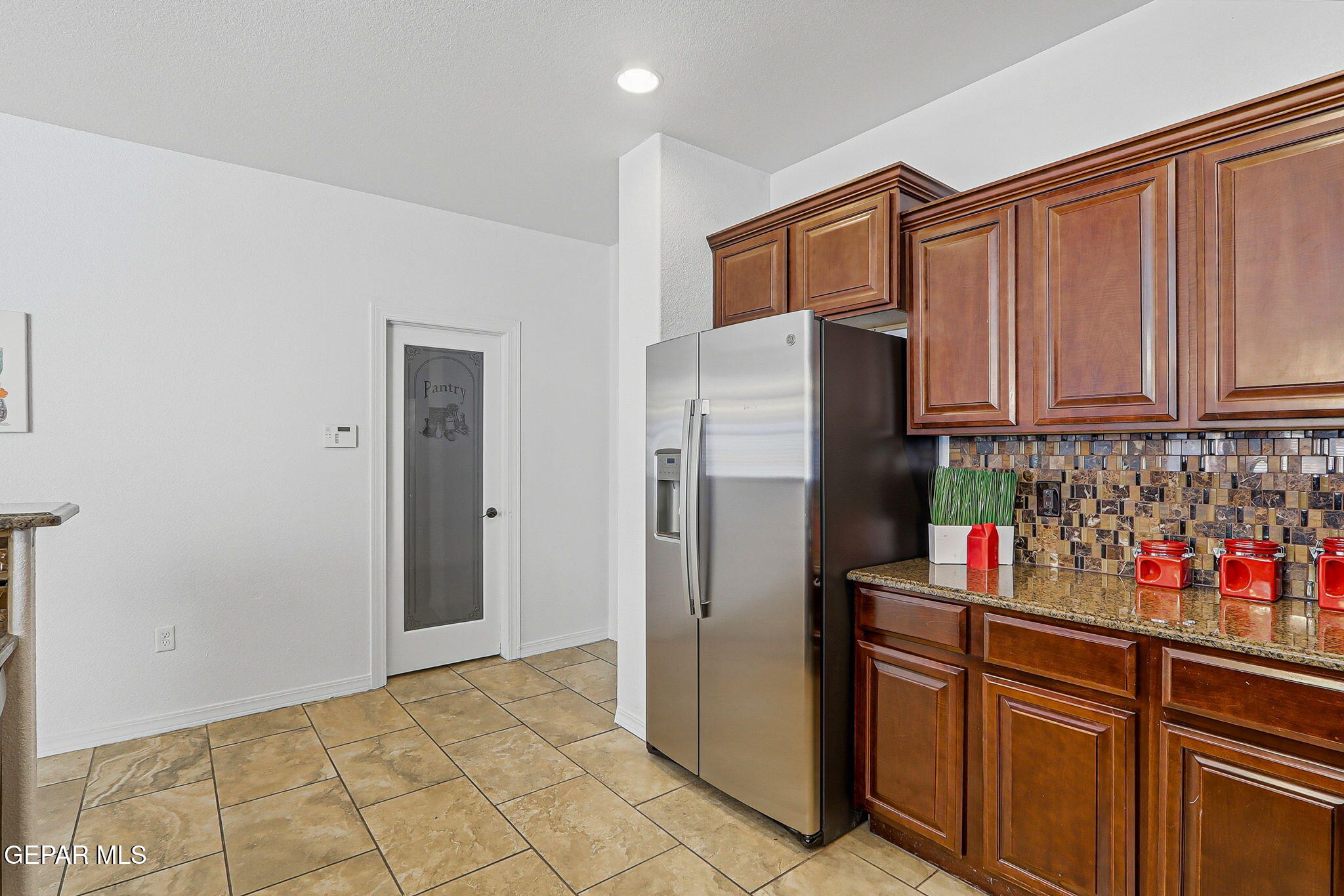 520 Gomez Road El Paso, TX 79932 - Photo 27 of 72 a kitchen with stainless steel appliances granite countertop a refrigerator and a sink
