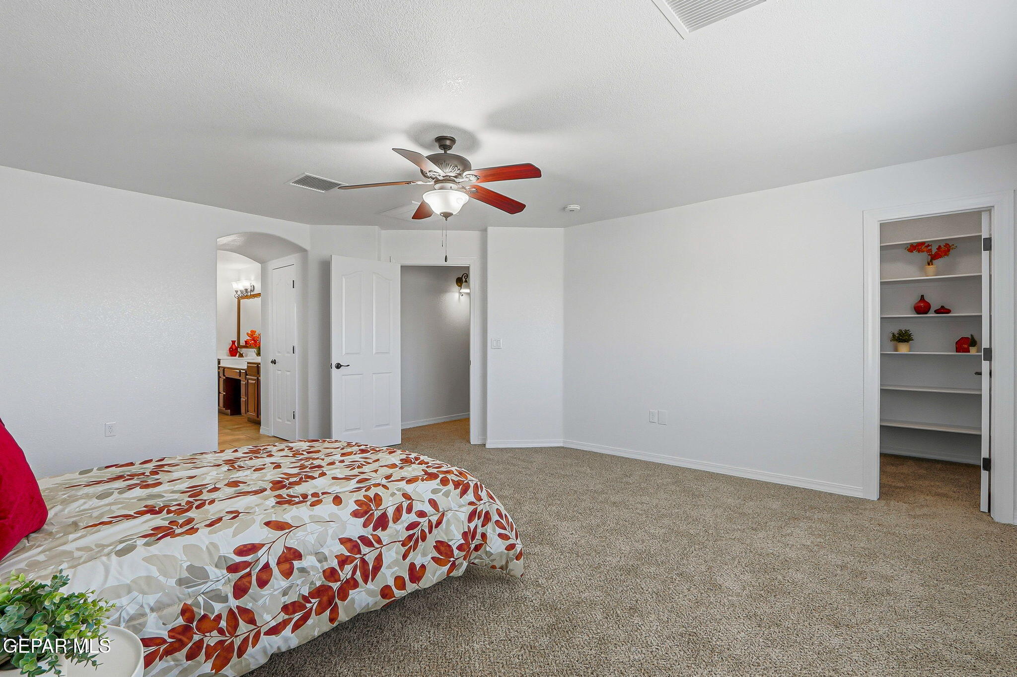 520 Gomez Road El Paso, TX 79932 - Photo 50 of 72 a bedroom with a large bed and a chandelier