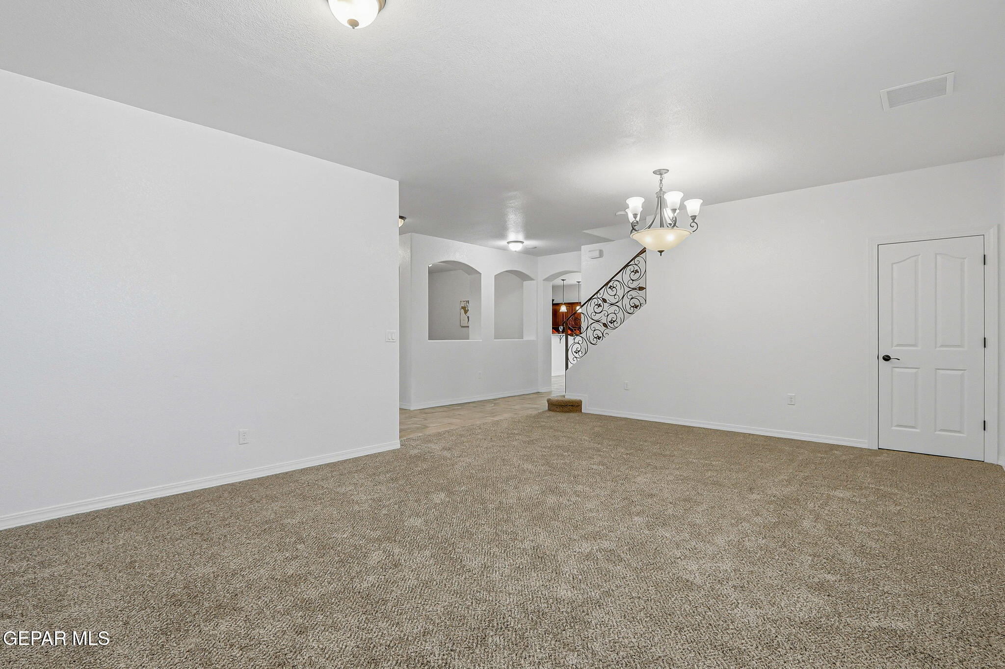520 Gomez Road El Paso, TX 79932 - Photo 9 of 72 an empty room with a chandelier fan and windows