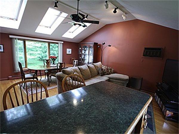 43 Little Farms Road Framingham, MA 01701 - Photo 9 of 20 a view of a dining room with furniture a chandelier and large windows