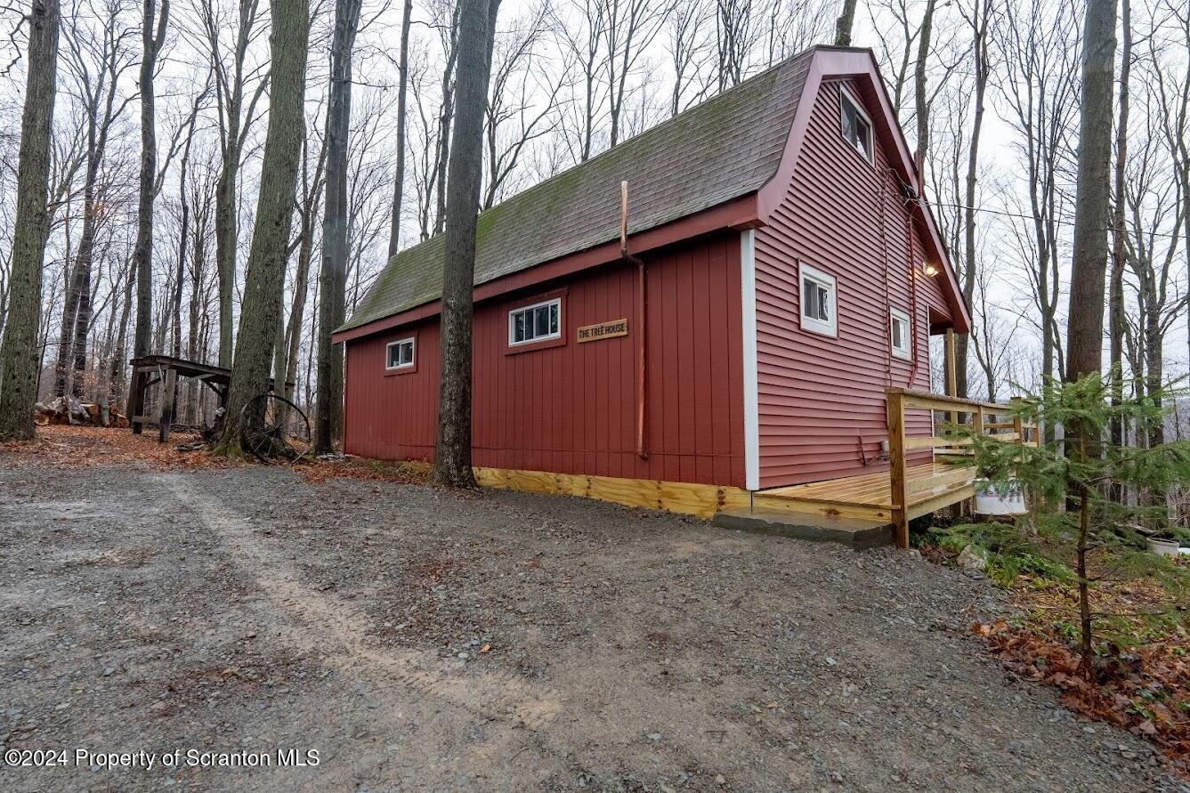 18285 Pa-92 Jackson, PA 18825 - Photo 3 of 49 a view of backyard with large trees and wooden fence