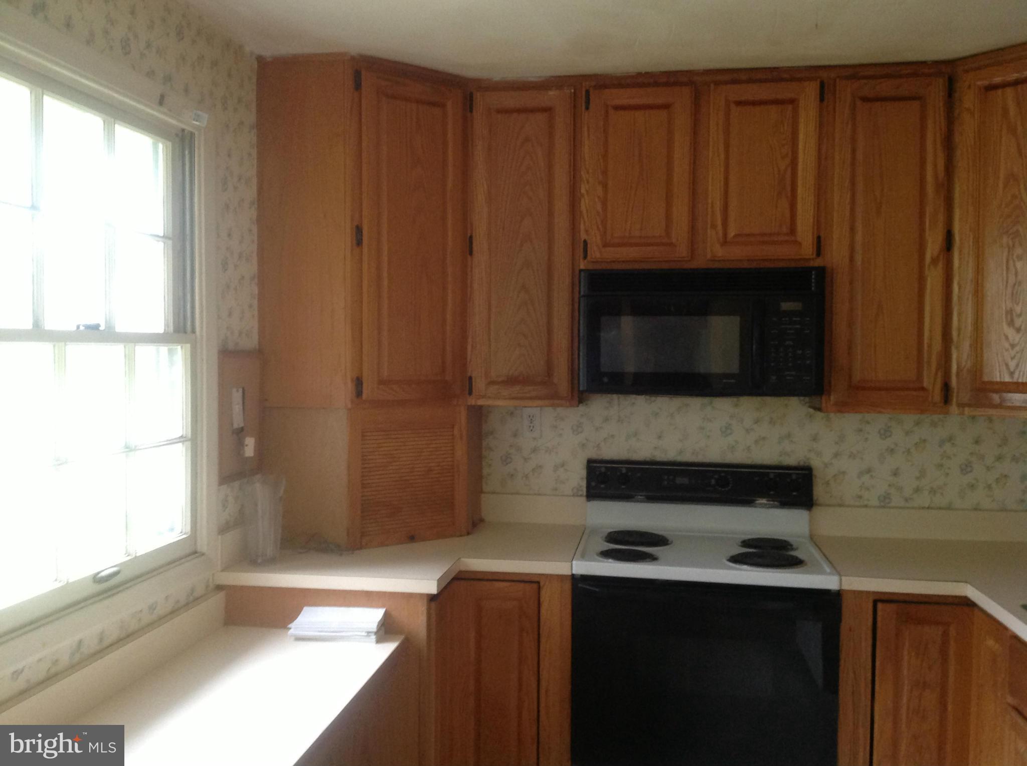 12701 Barbara Road Silver Spring, MD 20906 - Photo 11 of 21 a kitchen with a stove a microwave and a window