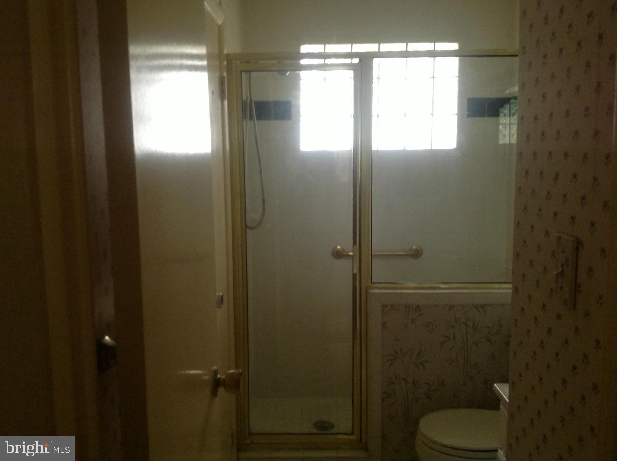 12701 Barbara Road Silver Spring, MD 20906 - Photo 15 of 21 a bathroom with a toilet and a shower curtain