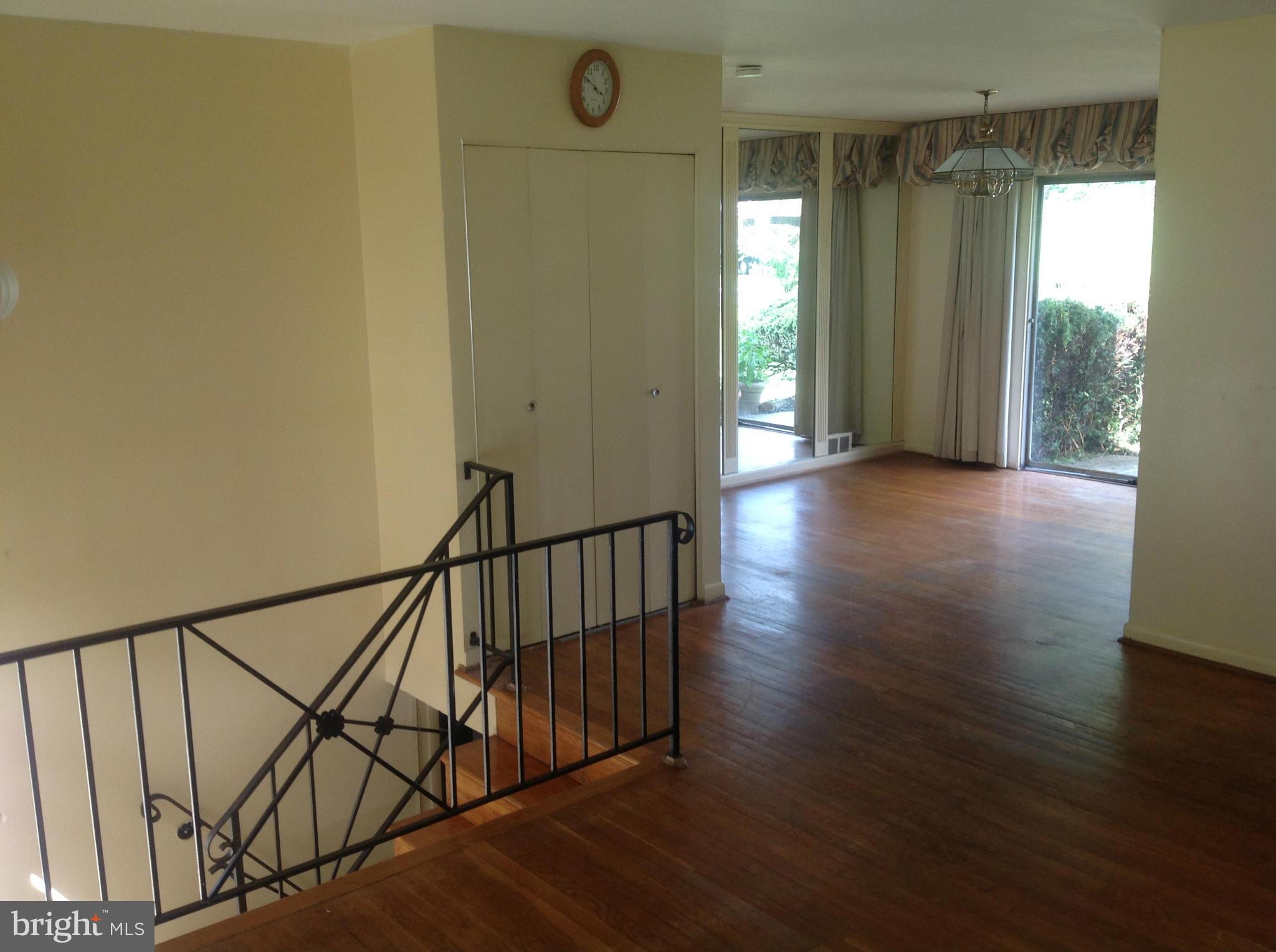 12701 Barbara Road Silver Spring, MD 20906 - Photo 7 of 21 a view of a hallway with wooden floor and staircase