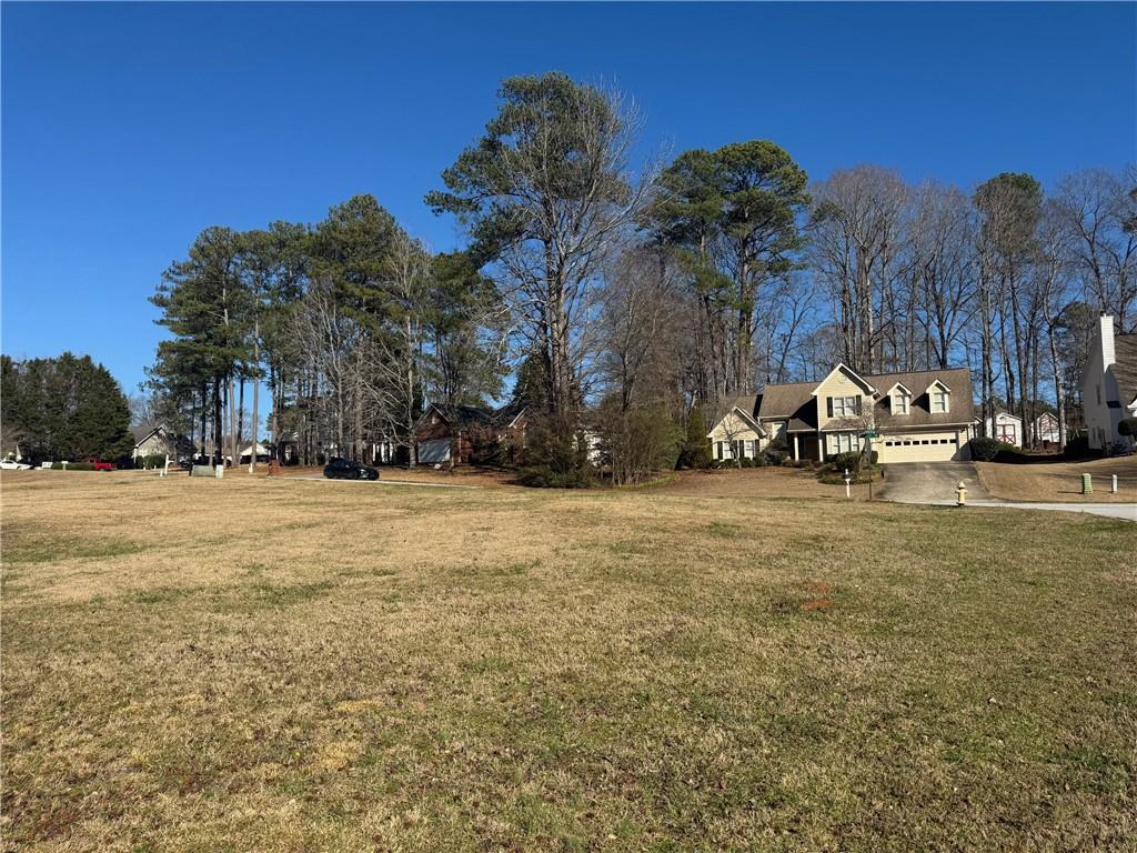 245 Camerons Way Covington, GA 30016 - Photo 6 of 10 a view of outdoor space with garden and trees