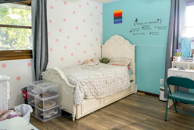 a bedroom with a bed and a window