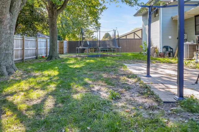 a view of a house with a yard and sitting area