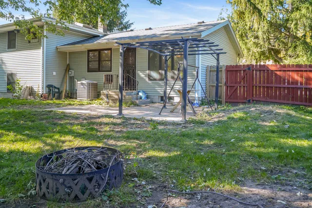 a view of a house with a yard and sitting area
