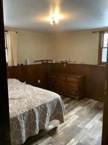 a bedroom with a bed and a mirror