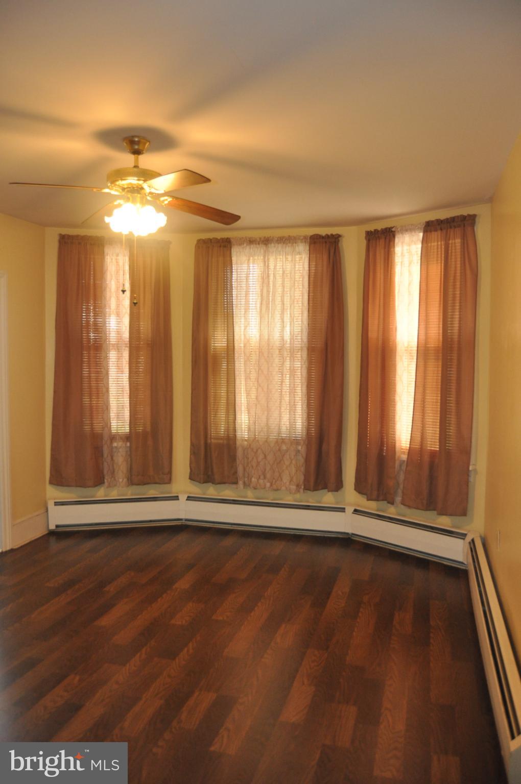 540 South 2nd Street Lykens, PA 17048 - Photo 15 of 42 an empty room with wooden floor and windows