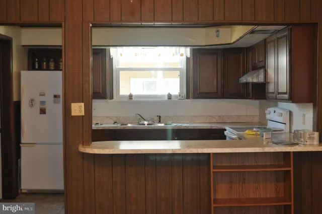 a kitchen with a sink and a refrigerator
