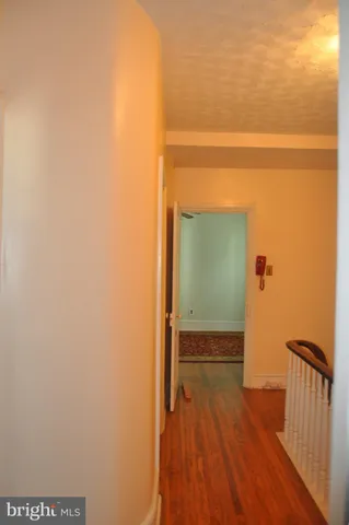 a view of hallway with wooden floor