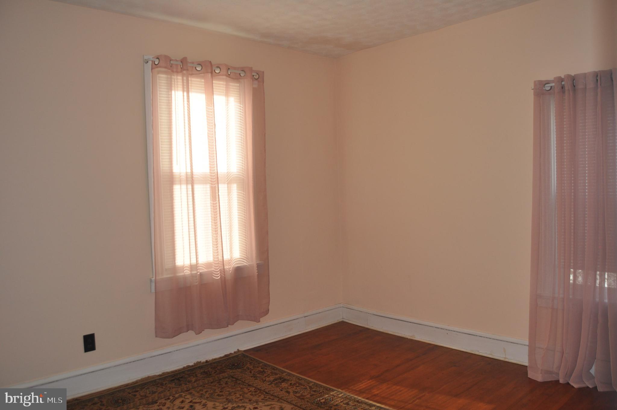 540 South 2nd Street Lykens, PA 17048 - Photo 32 of 42 an empty room with wooden floor and windows
