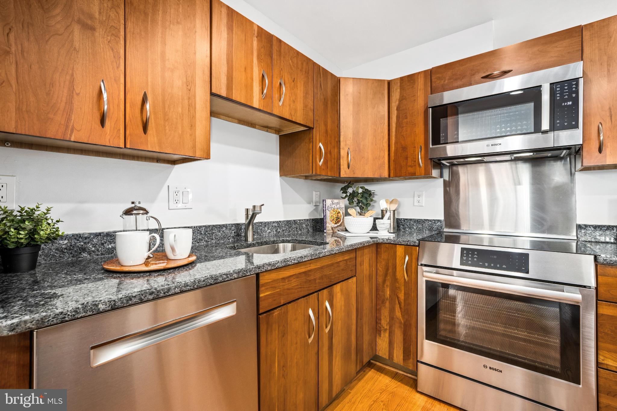 345 O Street Southwest Washington, DC 20024 - Photo 15 of 64 a kitchen with granite countertop stainless steel appliances a stove microwave and sink