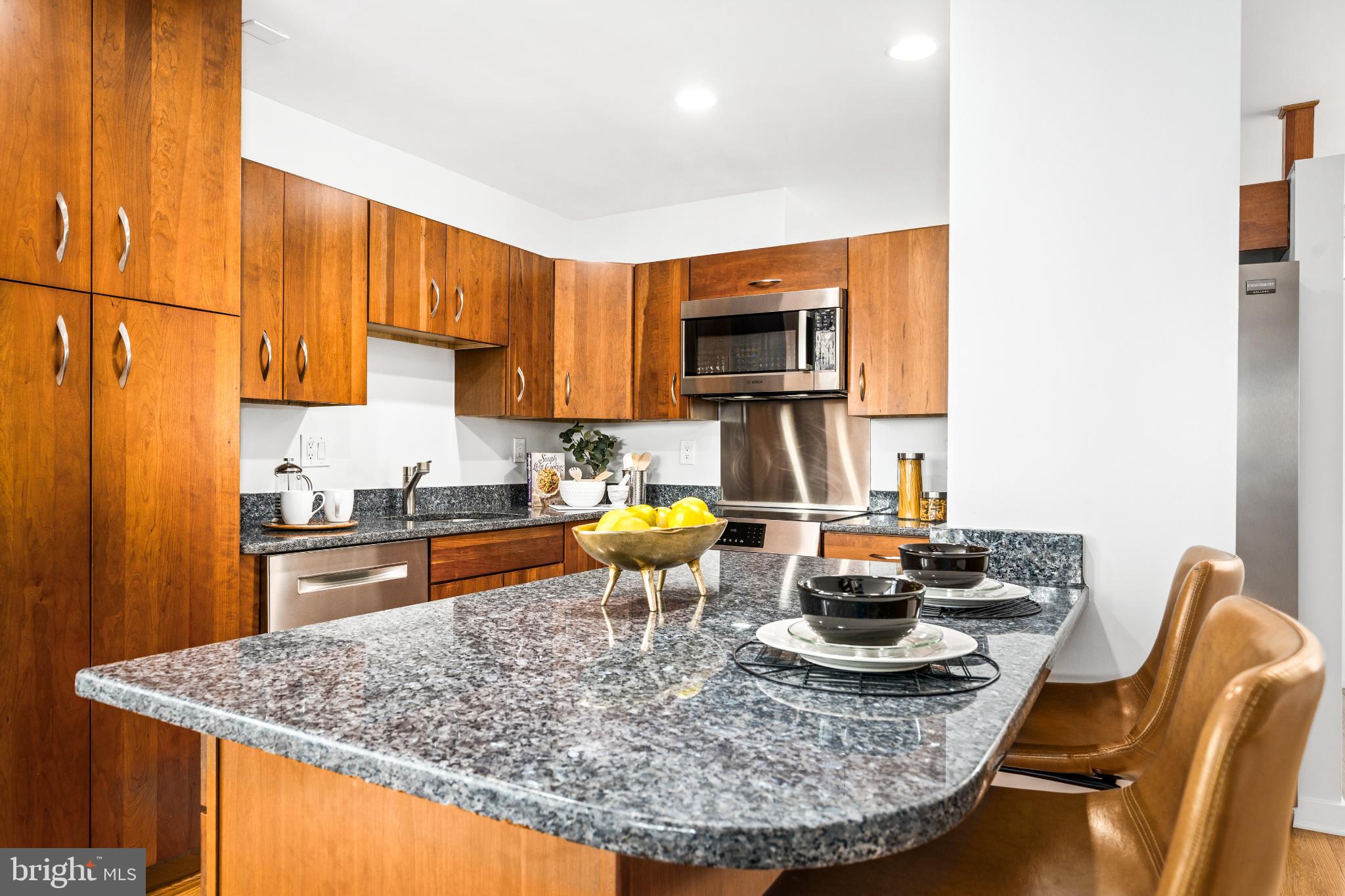345 O Street Southwest Washington, DC 20024 - Photo 19 of 50 Modern kitchen with rich wood cabinetry.
