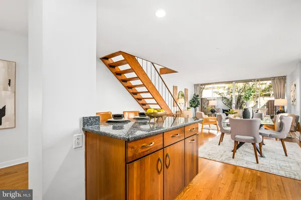 a kitchen with stainless steel appliances granite countertop a refrigerator a stove top oven a sink and dishwasher